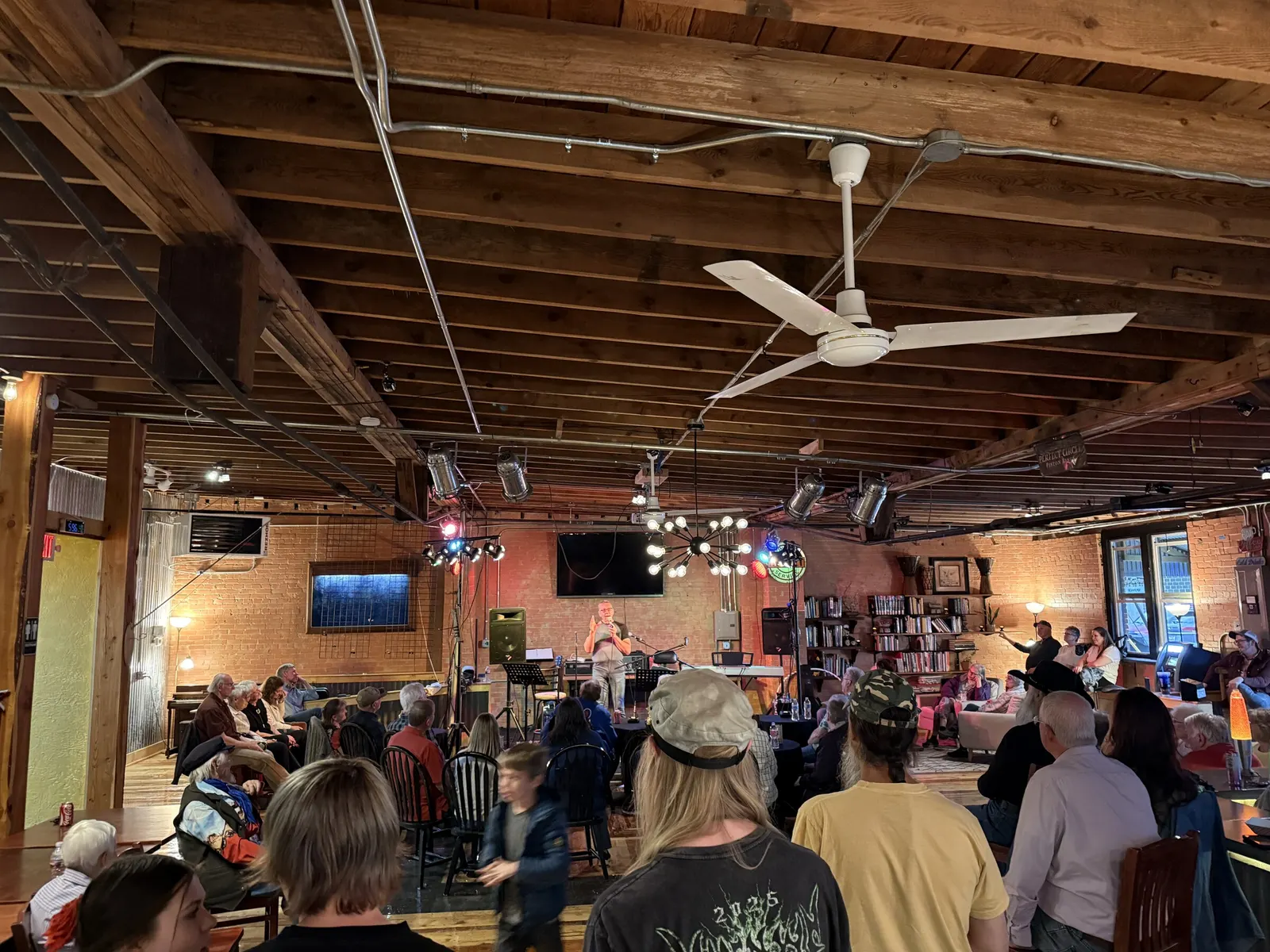 Full room facing the stage at a live show