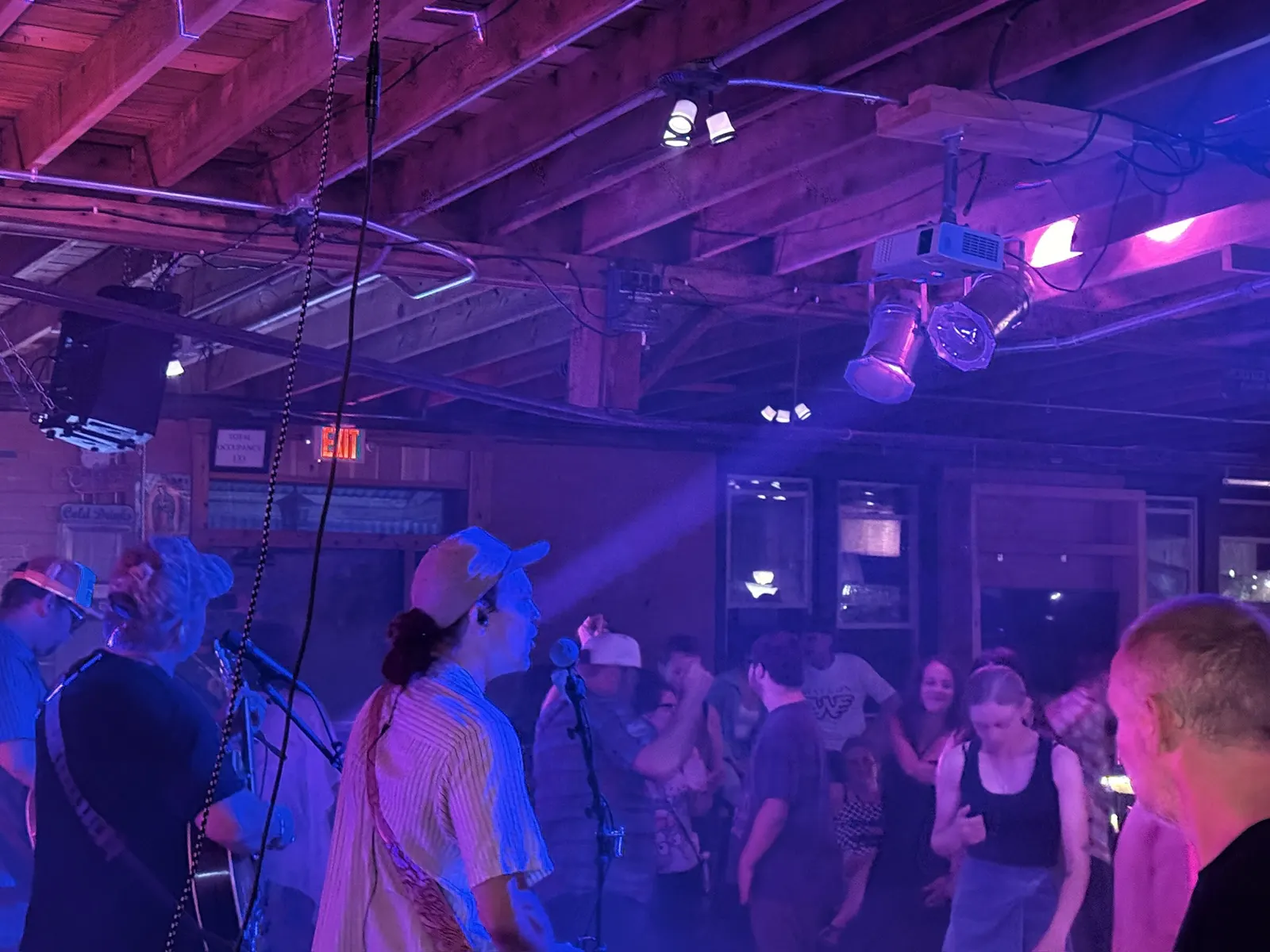 Band and dancers in blue-violet light